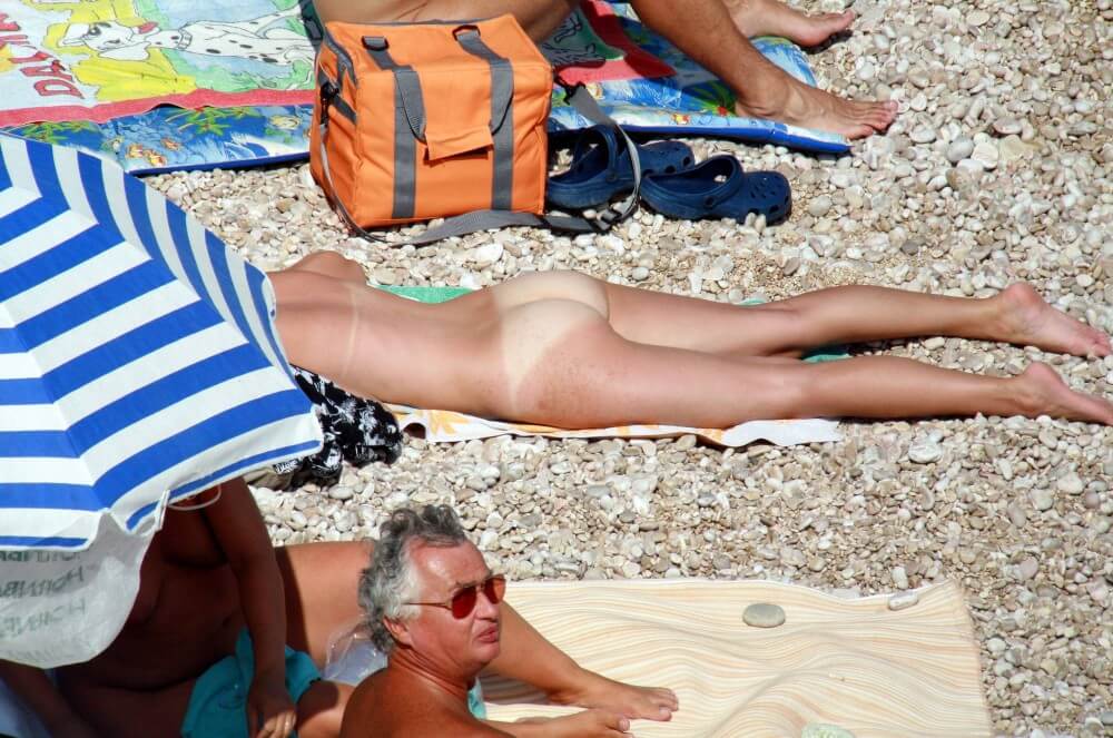 Naturists Beach Relaxation pics - A defining feature of naturism is the absence of clothing