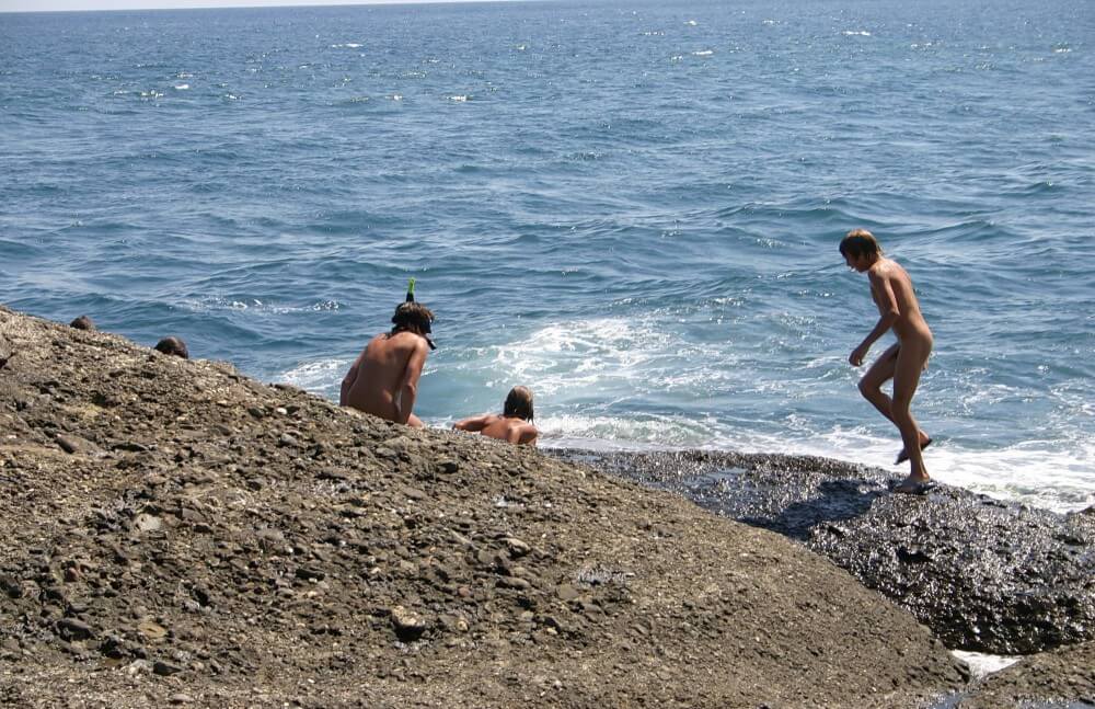 Leaning Against Hit Rocks pics - Growing up on a nude beach